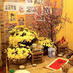 a room with yellow flowers and pictures on the wall