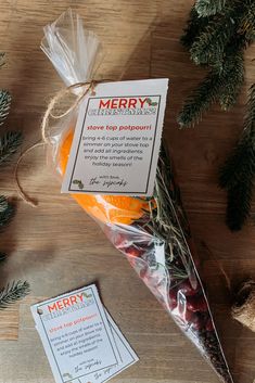 a bag of candy sitting on top of a wooden table next to pine cones and christmas decorations