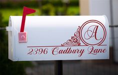 a white mailbox with a red ribbon attached to it and the name cadbury lane