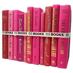 a row of pink books sitting on top of each other