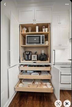 an open cabinet in the middle of a kitchen