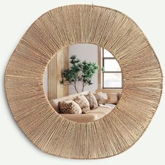 a living room with a round mirror on the wall and couch in front of it