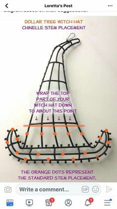 an orange and black wire sculpture on top of a white wall with words written below it