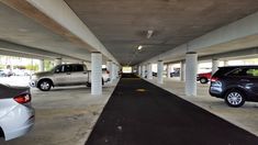 an empty parking garage with several cars parked in the space next to eachother