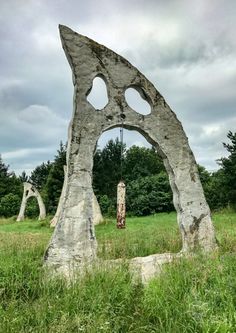 a large rock structure in the middle of a field