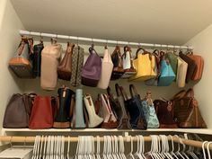 a closet filled with lots of purses and handbags