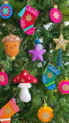 an ornament is hanging on the christmas tree, decorated with colorful felt ornaments