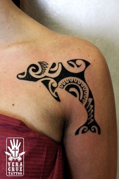 a woman with a tattoo on her shoulder