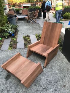 a wooden chair sitting on top of a cement ground