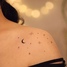 a woman's shoulder with stars and a crescent tattoo on her left side breast