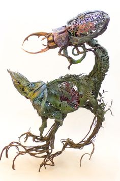 two sculptures made out of plants and animals