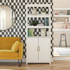 a yellow chair sitting in front of a white book shelf next to a wall mounted mirror