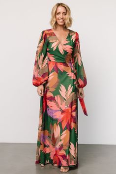 True wrap style for your every vacay need Green with multicolor tropical floral print Chiffon material that flows beautifully True wrap style with waist tie Flattering surplice neckline Long sleeves with elastic cuffs Maxi skirt length Fully lined, excluding sleeves Self and Lining: 100% Polyester Trina is 5'6, cup size 32D, size 2 and is wearing size S Floral Print Wrap Dress For Beach, Floral Print Wrap Dress For Vacation, Floral Wrap Dress For Beach, Green Tie Waist Wrap Dress For Vacation, Floral Print Maxi Wrap Dress For Vacation, Printed V-neck Wrap Dress For Vacation, Summer Floral Print Wrap Dress For Vacation, Multicolor Floral Print Wrap Dress For Beach, Tropical Wedding Guest Dress