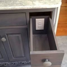 an open drawer in the middle of a kitchen counter with text overlay that reads, 1 add outlets to drawers to keep clutter off of the table top