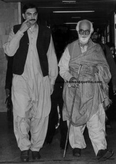 an old photo of two men walking down the street with their canes in hand