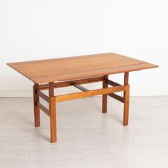 a wooden table sitting on top of a white tile floor