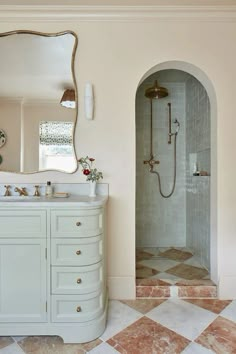 a bathroom with two sinks and a large mirror on the wall next to a walk in shower