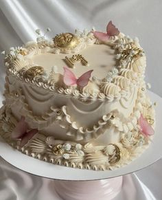 a wedding cake with white frosting and pink butterflies