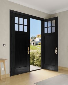 an empty room with two black doors open