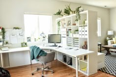 a room with a desk, chair and bookshelf filled with various items in it