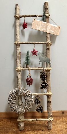 a ladder made out of branches with ornaments hanging from the top and on it's sides