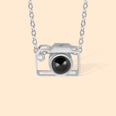 [DELICATE DESIGN]: This necklace with a camera charm pendant and is available in silver, gold, and rose gold. The pendant is inlaid with a projection stone and can engrave any photo in the middle of the projection stone. Put the photo inside the camera pendant when they see the photo, they will remind of the good times. This tiny camera pendant is delicate and simple, perfect for stacking or layering with other jewelry. 
[MATERIAL]: The customized photo projection necklace is made of high-quality 925 sterling silver, a high-quality necklace that does not harm the skin. The necklace is comfortable and suitable for everyday wear. 
[PHOTOGRAPHER GIFT]: A camera charm necklace is lovely for giving as gifts for all occasions and any girl with a passion for photography will love this sweet lit Camera Pendant, Photo Projection Necklace, Camera Charm, Tiny Camera, Projection Necklace, Necklace Length Guide, Photographer Gifts, Necklace Chain Lengths, Delicate Design