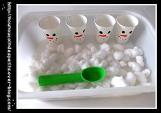 there are five cups and spoons in a tray with cotton balls on it,