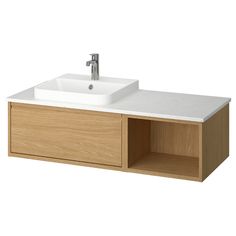 a bathroom sink with a wooden cabinet underneath it and a faucet on the side