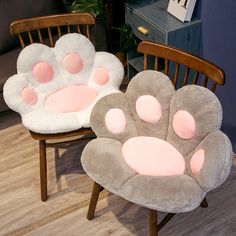 two chairs with paw prints on them sitting next to each other in a living room