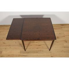 a wooden table sitting on top of a hard wood floor