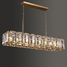 a large rectangular chandelier hanging from a chain with crystal cubes on it