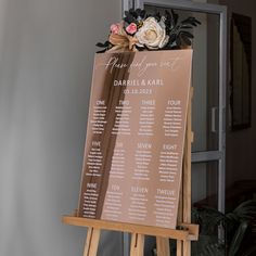 a wooden easel with a seating plan on it