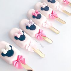 a row of toothbrushes decorated with minnie mouse heads and bowknots