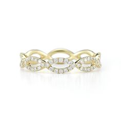 an 18k yellow gold ring with white diamonds set in the middle, on a white background