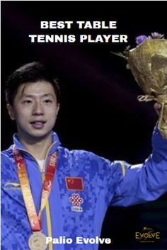 the man is holding up his gold medal