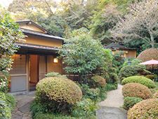 a small house surrounded by trees and bushes