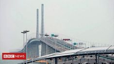 an overpass with cars driving on it near the ocean