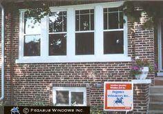 a brick house with a sign for windows inc