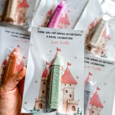 a person holding up a card with an image of a castle on it