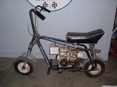 an old motorcycle is parked next to a sign