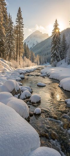 the sun is setting over a snowy mountain stream