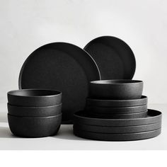 the black dishes are stacked on top of each other