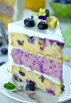 a slice of cake with blueberries and lemon on top