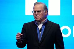 a man standing in front of a blue screen