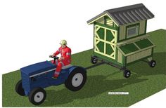 a man riding on the back of a blue tractor next to a small wooden shed