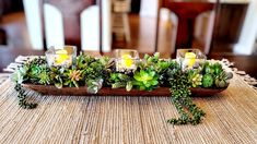 a table with candles and succulents on it