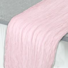 a bed with a pink blanket on top of it