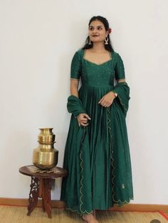 Hand embroidered Anarkali with hand embroidered / anarkali suit set / hand embroidery anarkali gown USA / green designer wedding dress with embroidery / Indian dresses/ voggish / green pure silk  dress         Looking for a perfect indian dress/anarkali/suit sets that are trendy, unique and easy to carry !! yess, You are at the right place. we carry such versatile pieces of anarkalis and suit sets that really let you stand out in any occassion !!      featuring this beautiful anarkali dress in dark green color with simple hand embroidery at the front body part with elbow sleeves as shown made with pure chanderi with heavy gear as shown paired with matching scallop embroidered Kota dupatta !! A very classy, beautiful look makes your occasion Perfect !! Ready to ship !!  Details :  - color : Green Maxi Length Traditional Wear With Cutdana, Green Cutdana Anarkali Set For Navratri, Green Chanderi Anarkali Set With Cutdana Details, Green Chanderi Anarkali Set With Cutdana, Green Anarkali Set For Navratri Designer Wear, Designer Green Anarkali Set For Navratri, Green Floor-length Kurta With Cutdana Detail, Green Floor-length Kurta With Cutdana, Green Floor-length Cutdana Kurta