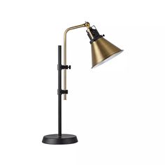 a black and gold desk lamp on a white background, with the light turned off