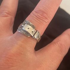 a person's hand with a silver ring on it